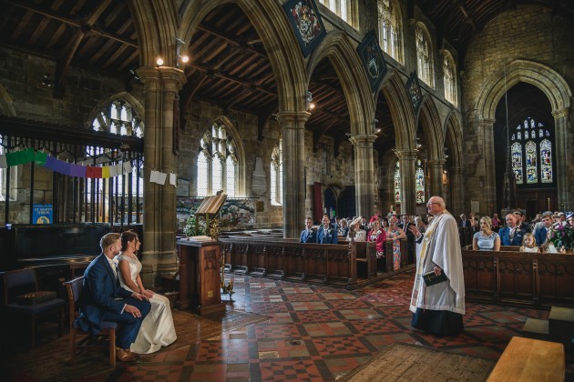 Stan-Seaton-Photography-bride-and-groom-listening-to-the-vicar