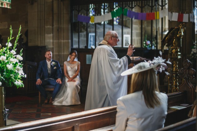 Stan-Seaton-Photography-bride-and-groom-listening-to-the-vicar