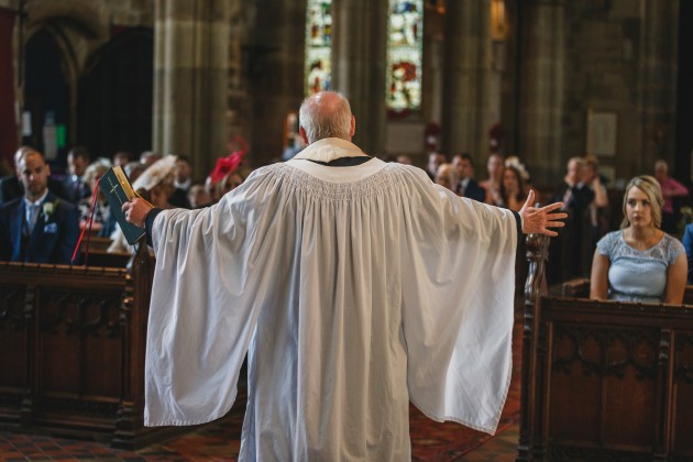 Stan-Seaton-Photography-bride-and-groom-listening-to-the-vicar