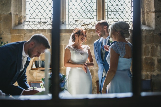 Stan-Seaton-Photography-groom-signing-the-register