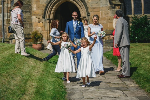 Stan-Seaton-Photography-bridesmaids-walking-out-of-the-church