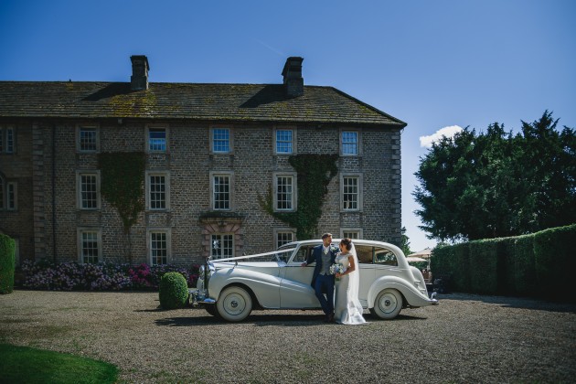 tan-Seaton-Photography-Headlam-Hall-Bride-and-groom-with-the-wedding-car