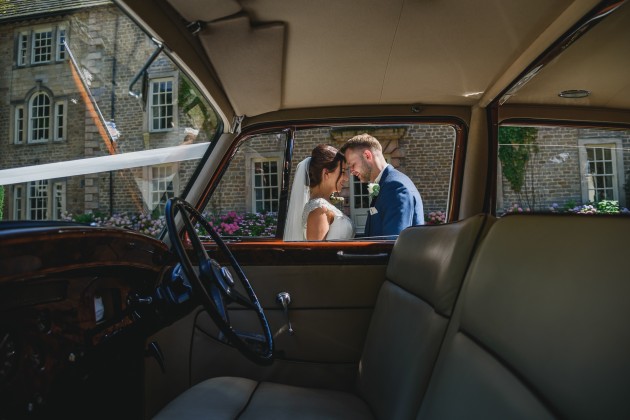 tan-Seaton-Photography-Headlam-Hall-Bride-and-groom-with-the-wedding-car