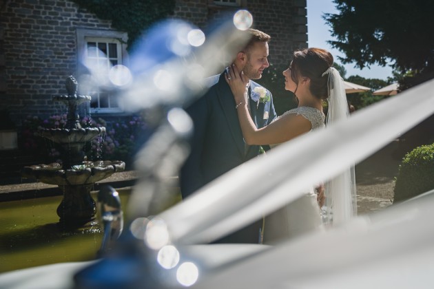 tan-Seaton-Photography-Headlam-Hall-Bride-and-groom-with-the-wedding-car