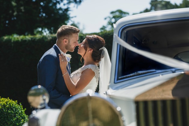 tan-Seaton-Photography-Headlam-Hall-Bride-and-groom-with-the-wedding-car