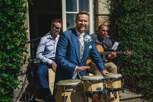 tan-Seaton-Photography-Headlam-Hall-groom-playing-the-drums