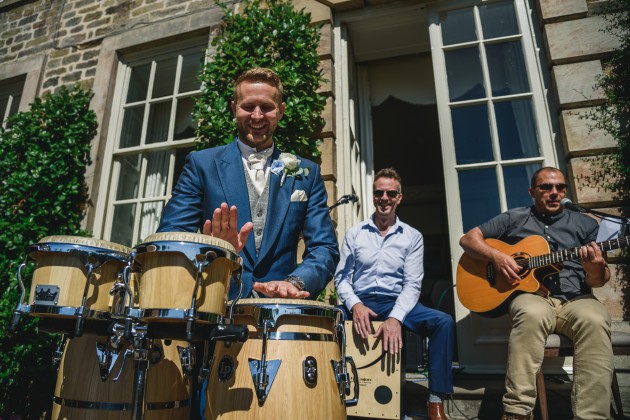 tan-Seaton-Photography-Headlam-Hall-groom-playing-the-drums