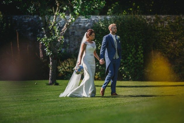 Stan-Seaton-Photography-Headlam-Hall-wedding-bride-and-groom-walking-on-the-lawn