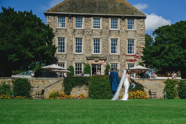 Stan-Seaton-Photography-Headlam-Hall-wedding-bride-and-groom-walking-on-the-lawn