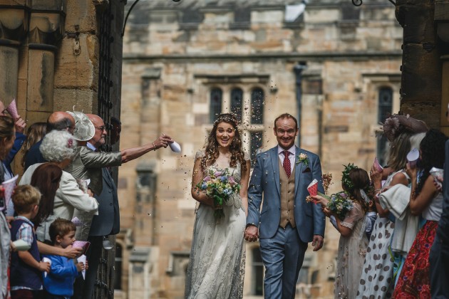 053 Durham-Castle-Wedding-Photographer-Stan-Seaton-bride-and-groom-walking-through-the-confetti.JPG