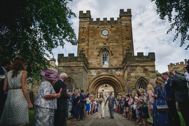 054 Durham-Castle-Wedding-Photographer-Stan-Seaton-bride-and-groom-walking-through-the-confetti..JPG