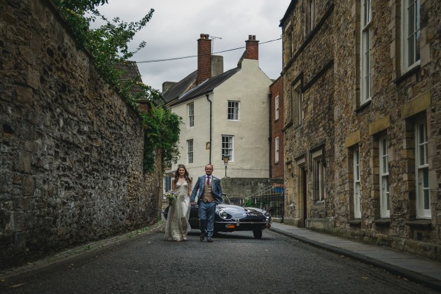 068 Durham-Castle-Wedding-Photographer-Stan-Seaton-bride-and-groom-walking-through-the-cobbled-streets.JPG